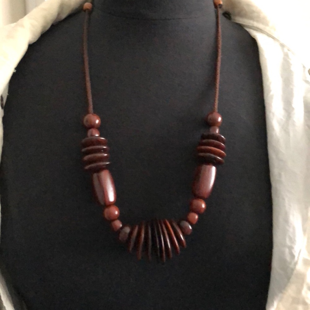 Mahogany various wood beads on adjustable string.